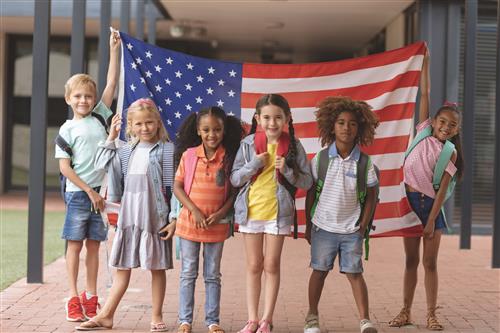 6 students holding American flag