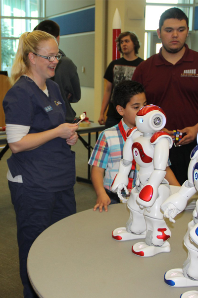 Visitor looks at a student's robotics display