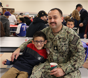 military dad with arm around son